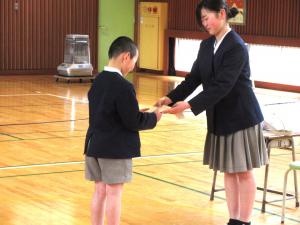 ４年生にプレゼントを渡す６年生