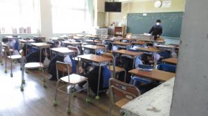 机の下に避難する様子